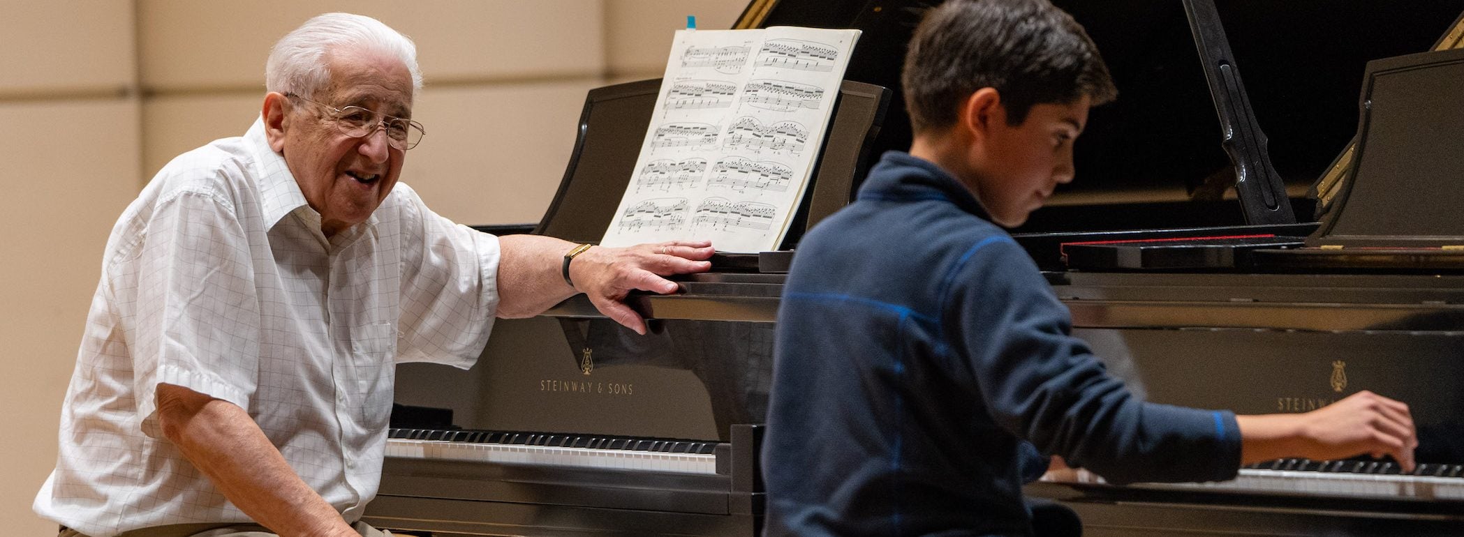 Cristian Makhuli plays while Hungarian pianist Peter Frankl gives instruction. (ECU Photo by Cliff Hollis)